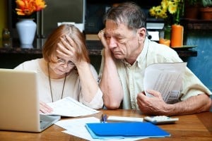 An elderly couple is reviewing their debt as they search from chapter 13 bankrupcty attorneys near me.