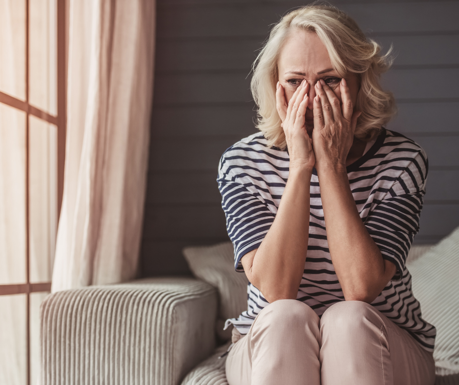 distraught woman holding face